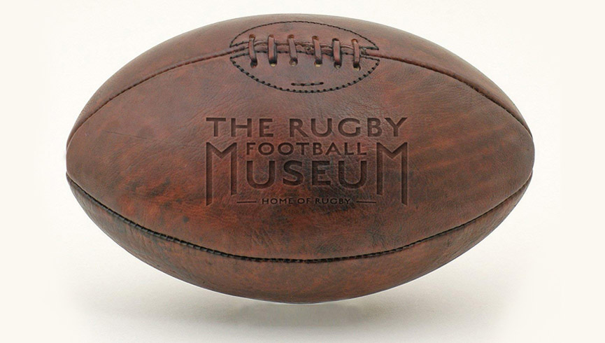 An old rugby ball with The Rugby Football Museum logo on